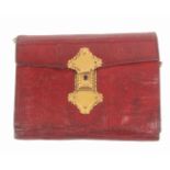 A Georgian red leather hussif, with elaborate gilt clasp, of wallet form with six division skein