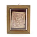 A charming miniature sampler, red on white in cross stitch, worked with an upper case alphabet