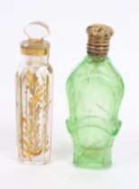 Two early 19th Century glass perfume bottles, one in green glass with gilt metal fancy gilt cover,