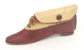 A novelty sewing companion in the form of a shoe, circa 1920, in brown leather and cloth with