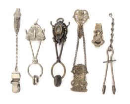 Six Victorian and Edwardian skirt lifters, comprising two of scissor form, a slider and three of