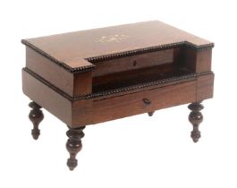 A French rosewood sewing box in the form of a rectangular piano, raised on four turned legs