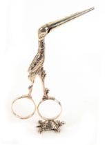 A pair of continental silver ribbon scissors, in the form of stork opening to reveal a swaddled baby