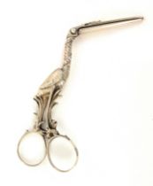 A pair of continental silver ribbon scissors, in the form of a stork opening to reveal a fish in its