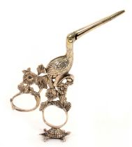 A pair of continental silver ribbon scissors, in the form of a stork, its legs amid flowering