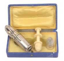 A French silver sewing compendium in the form of a torpedo in fitted case, circa 1915, the