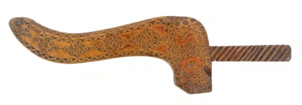 A carved pale wood knitting sheath, one side with extensive chip carved decoration with the initials