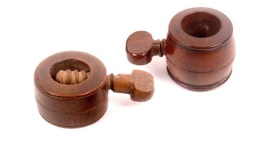 Two early 19th Century screw form wooden nut crackers, one of barrel form with top screw, 7cms,