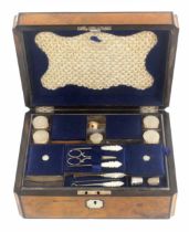 A burr walnut fitted sewing box, circa 1870, of rectangular form with concave and ebony lined