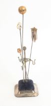 Hat pins and hat pin stands, comprising three gold and one gilt hat pin, five silver examples with