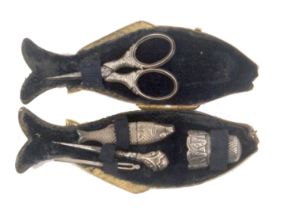 A scarce silver sewing set for a child contained in a brass case in the form of a fish, circa