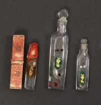 Three 19th Century clear glass scent bottles, two with verre eglomise style green glass and gilt