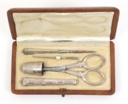 A continental five piece silver sewing set in a brown leather rectangular case, circa 1910, the case