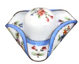 An enamel patch box in the form of a tricorn hat, painted with flowering branches, the base with