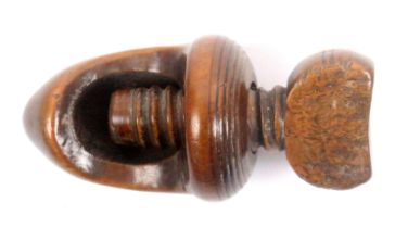 A late 18th/early 19th Century screw form nut cracker, fruitwood, the acorn form body below a top