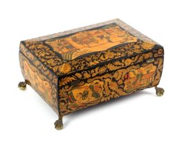 A fine Regency polychrome painted and penwork sewing box of sarcophogal form, raised on gilded brass