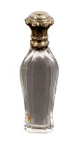 An attractive scent bottle, the baluster shaped glass body below a fancy silver gilt hinged cover