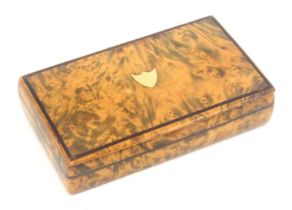 A burr walnut snuff box, of rectangular form with wooden hinge, the lid with a gold shield within an