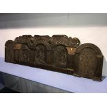 A heavily carved oak panel, 175cm long, 53cm high