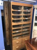 A haberdashery/shop fitting, with two rows of sixteen drawers, below four short drawers, with