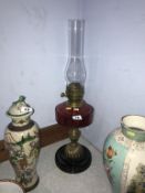 An oil lamp, with cranberry reservoir