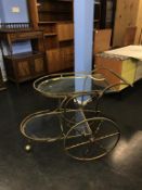 A metalwork and two tier glass tea trolley