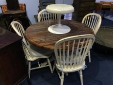 A circular table and four stick back Windsor chairs