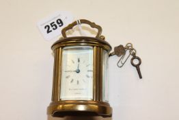 A small carriage clock (percussion pistol withdrawn)