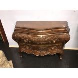 A Continental style walnut bombe commode chest, with carved drawers, 130cm wide