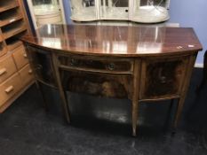 An Edwardian bow front sideboard