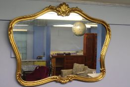 A gilt framed over mantle mirror, 103cm wide