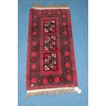 A modern Afghan mat, with red and black motifs, 50cm x 101cm and a modern Pakistani Prayer rug, with