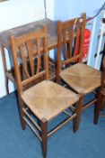 A pair of oak chairs and an occasional table