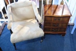 An Edwardian open armchair and a yew chest of drawers
