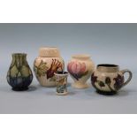 A modern Moorcroft cream jug and four vases