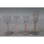 A 19th century engraved opaque air twist wine glass and three other opaque air twist glasses
