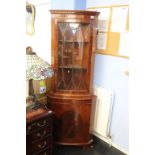 A mahogany corner cabinet