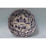 A large Oriental blue and white circular shallow dish, decorated with cranes and figures, 39cm