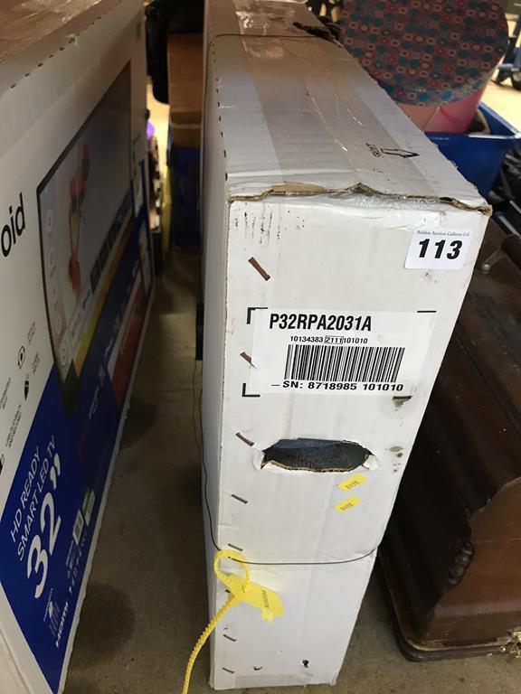 A boxed Polaroid 32" TV