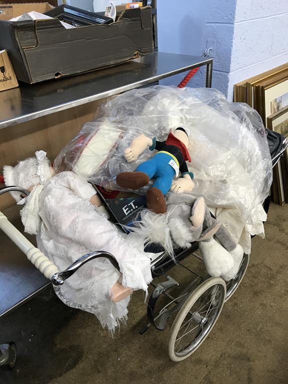 A pram and various dolls