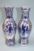 A pair of Chinese octagonal vases, in blue and white, decorated with female figures, signed in