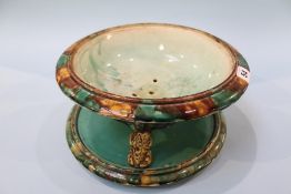 A 19th century Continental majolica strainer dish and stand, the dish being supported on three