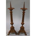 A pair of brass Prickett candlesticks, 43cm height