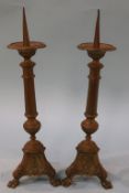 A pair of brass Prickett candlesticks, 43cm height