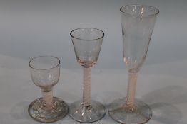 A 19th century opaque air twist glass, with bell shaped bowl and two others