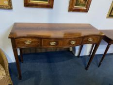 A reproduction mahogany serpentine fronted three drawer serving table, 37cm wide