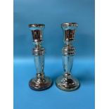 A pair of silver coloured glass candlesticks, 30cm high