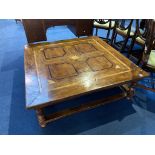 A large square coffee table with parquetry top, 191cm