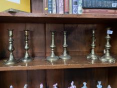 Three pairs of brass candlesticks