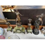 An Onyx and spelter three piece clock garniture and another spelter figure